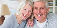 Happy older couple with full healthy smiles